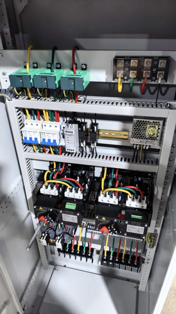 Interior of a fire pump control cabinet: dual power transfer, contactors and protection relays