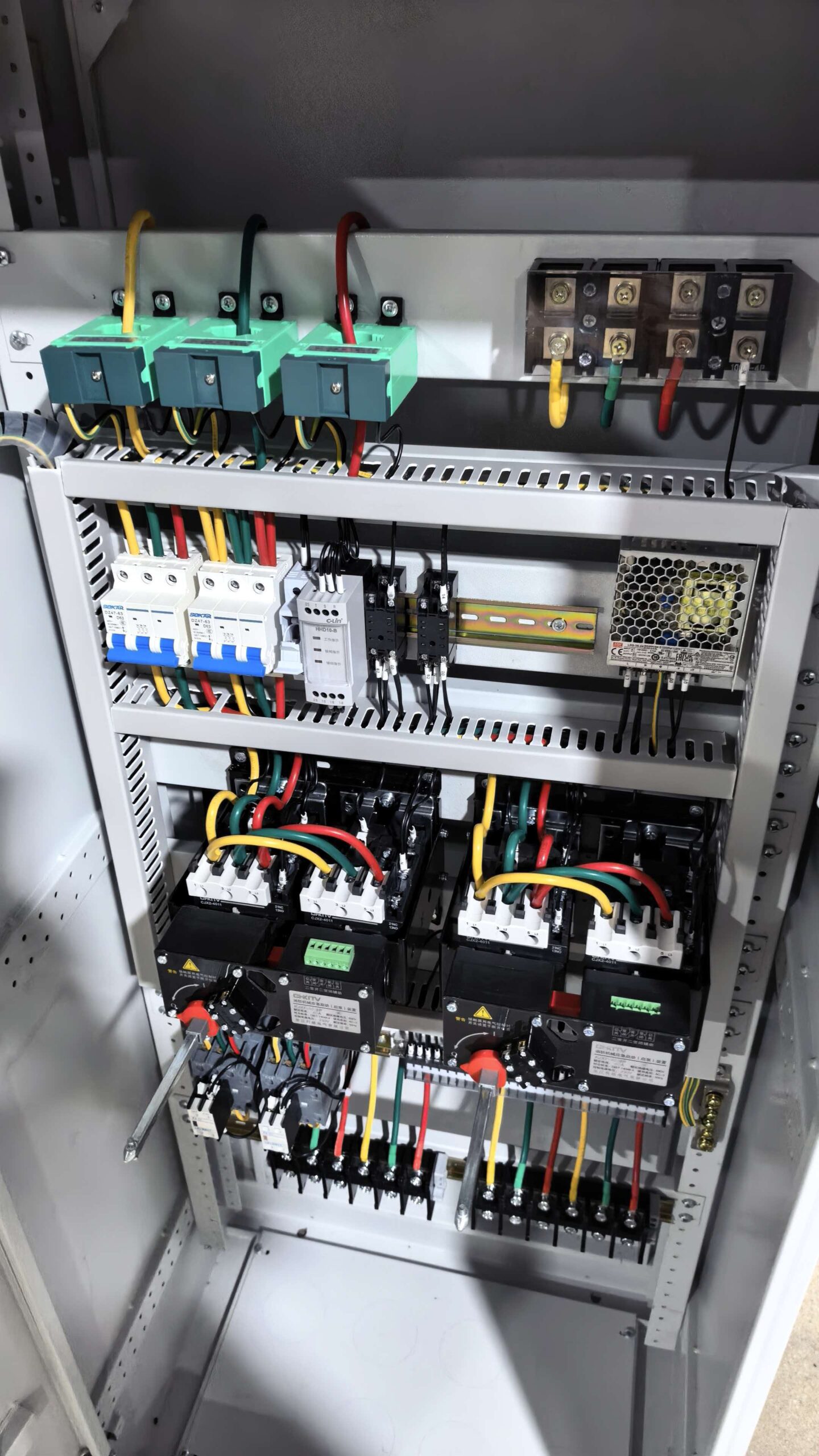 Interior of a fire pump control cabinet: dual power transfer, contactors and protection relays